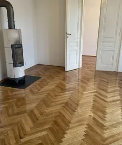 Fischgrätparkett in einem fertig eingerichteten Raum.